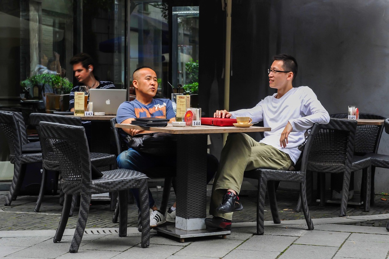 Two individuals at a table talking.
